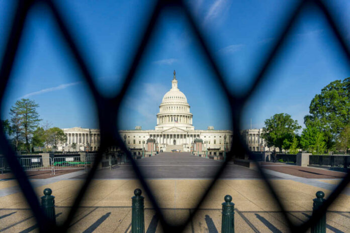 View of the U.S. Capitol building through a security fence