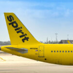 Spirit Airlines COLLAPSES: Travelers Left Stranded Close-up of the tail of a Spirit Airlines airplane at an airport