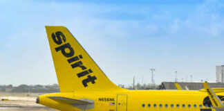 Close-up of the tail of a Spirit Airlines airplane at an airport