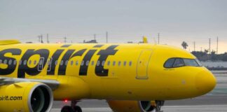A yellow Spirit Airlines airplane on the runway