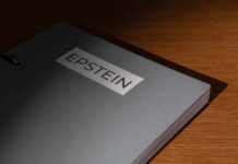 A metallic folder labeled 'EPSTEIN' resting on a wooden surface