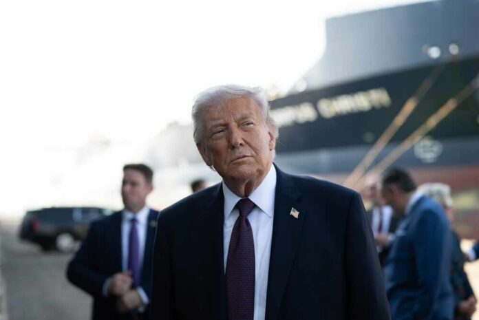 President,Donald,J.,Trump,Delivers,Remarks,On,Energy,At,The A political figure in a suit looking thoughtfully at an outdoor event with a ship in the background