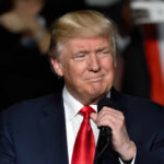 Trump Praises Democrat: Unexpected Mar-a-Lago Twist Donald Trump speaking at a rally with a microphone