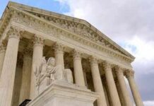 Supreme Court building with columns and statue