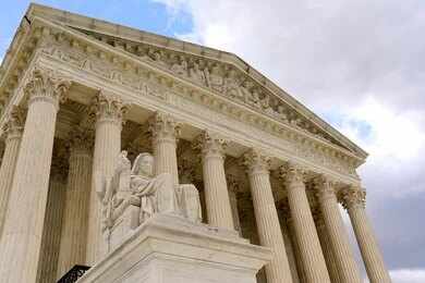 Supreme Court building with columns and statue