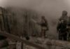Firefighters spray water into a smoke-filled structure