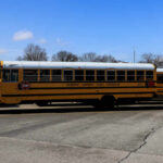 Watermelon Uproar Engulfs NJ Schools Yellow school buses parked in a lot under a blue sky