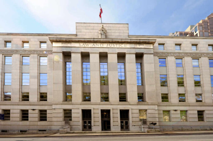 shutterstock2337384919jpg Facade of a government building with the words Law and Justice and a statue on top