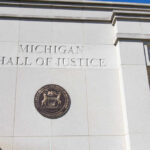 Exterior view of the Michigan Hall of Justice with the state seal