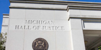 Exterior view of the Michigan Hall of Justice with the state seal