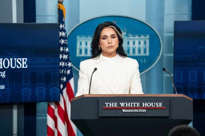 Woman in white suit speaking at White House press podium