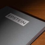 Congress Turns Heat On Epstein Insider A metallic folder labeled 'EPSTEIN' resting on a wooden surface