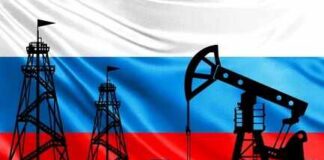 Oil pumpjack and drilling rigs silhouetted against the Russian flag