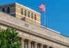 Facade of the United States Department of Agriculture building with an American flag