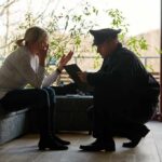 Ohio Homeowners Stun Cops — Not a Crime police officer speaking with distressed woman on a sofa
