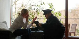 police officer speaking with distressed woman on a sofa