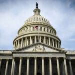 Reconciliation Blitz Sparks GOP Revolt The U.S. Capitol building with an American flag flying in front