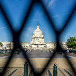 View of the U.S. Capitol building through a security fence