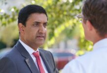 Terror Labels Ignite Washington Brawl Two professionals engaged in a conversation outdoors