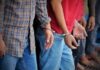 Hezbollah Circle Shaken: Singer Implicated Handcuffed people standing in a line