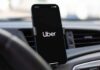Smartphone displaying the Uber app in a car