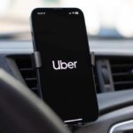Smartphone displaying the Uber app in a car