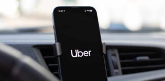 Smartphone displaying the Uber app in a car