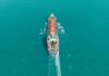 Oil Spike, Silicon Valley Panics Aerial view of a cargo ship navigating through turquoise waters