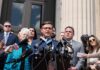 Freedom Fight Erupts Over Voting Rights A group of individuals at a press conference with a speaker at a podium