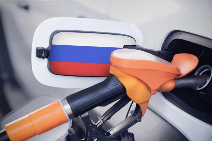 Fuel nozzle inserted into a car with a flag-themed fuel door