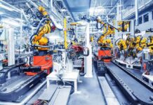 Automation Blitz Kneecaps Labor Power Industrial robots assembling parts on an automated factory line