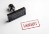 Mosque Visit Ignites Parental Uproar Rubber stamp with red lawsuit imprint on white paper