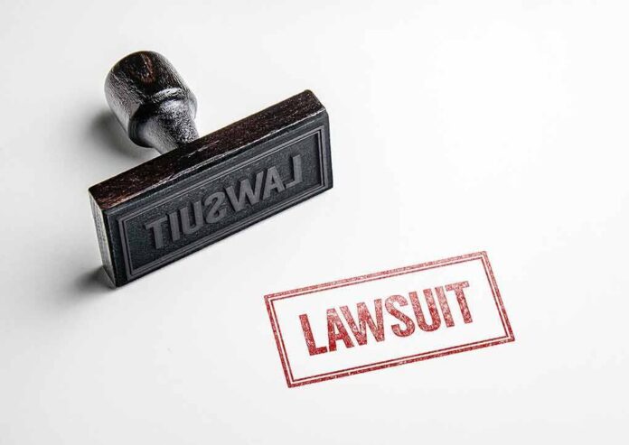 Rubber stamp with red lawsuit imprint on white paper
