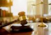 Judge TORCHES Botched Asylum Ruling Judge's gavel on a block with scales of justice in the background