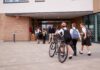 Students in uniforms arriving at a school entrance