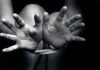 Hands bound with rope in black and white