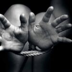 Hands bound with rope in black and white