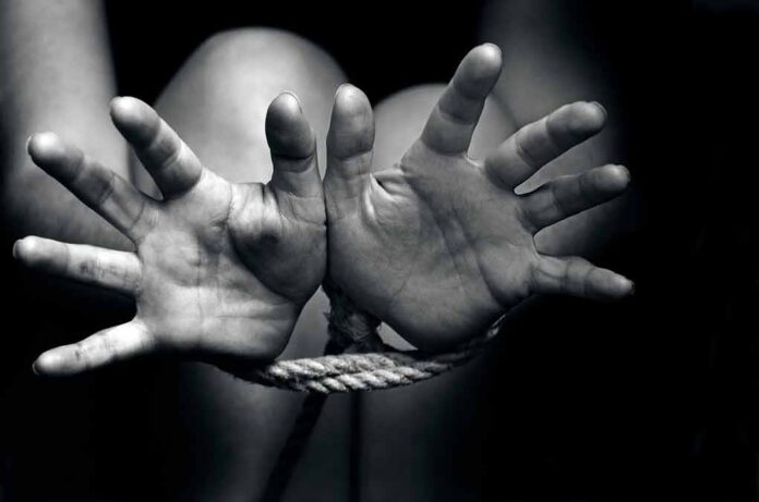 Hands bound with rope in black and white