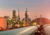 Oil refinery with pipelines at sunset