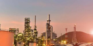 Oil refinery with pipelines at sunset