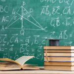 Math Crisis Rocks UC Admissions Stack of books with graduation cap in front of chalkboard with math formulas