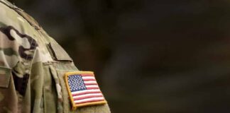 american flag patch on camouflage uniform sleeve