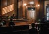 Judge presiding in a wood-paneled courtroom