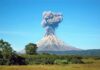 Volcano erupting with a towering ash plume