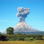 Volcano erupting with a towering ash plume