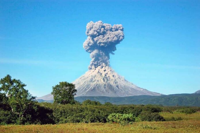 Volcano erupting with a towering ash plume