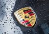 Porsche crest on wet car hood