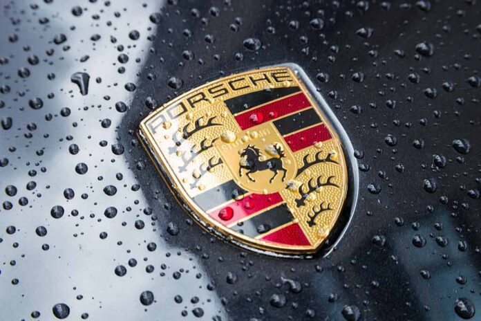 shutterstock_719355487 Porsche crest on wet car hood