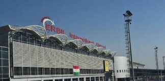 airport terminal exterior with modern facade and roadway