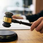 Judge Rejects Bid To Dismiss Homicide Case Judge's hand holding a gavel over a sound block